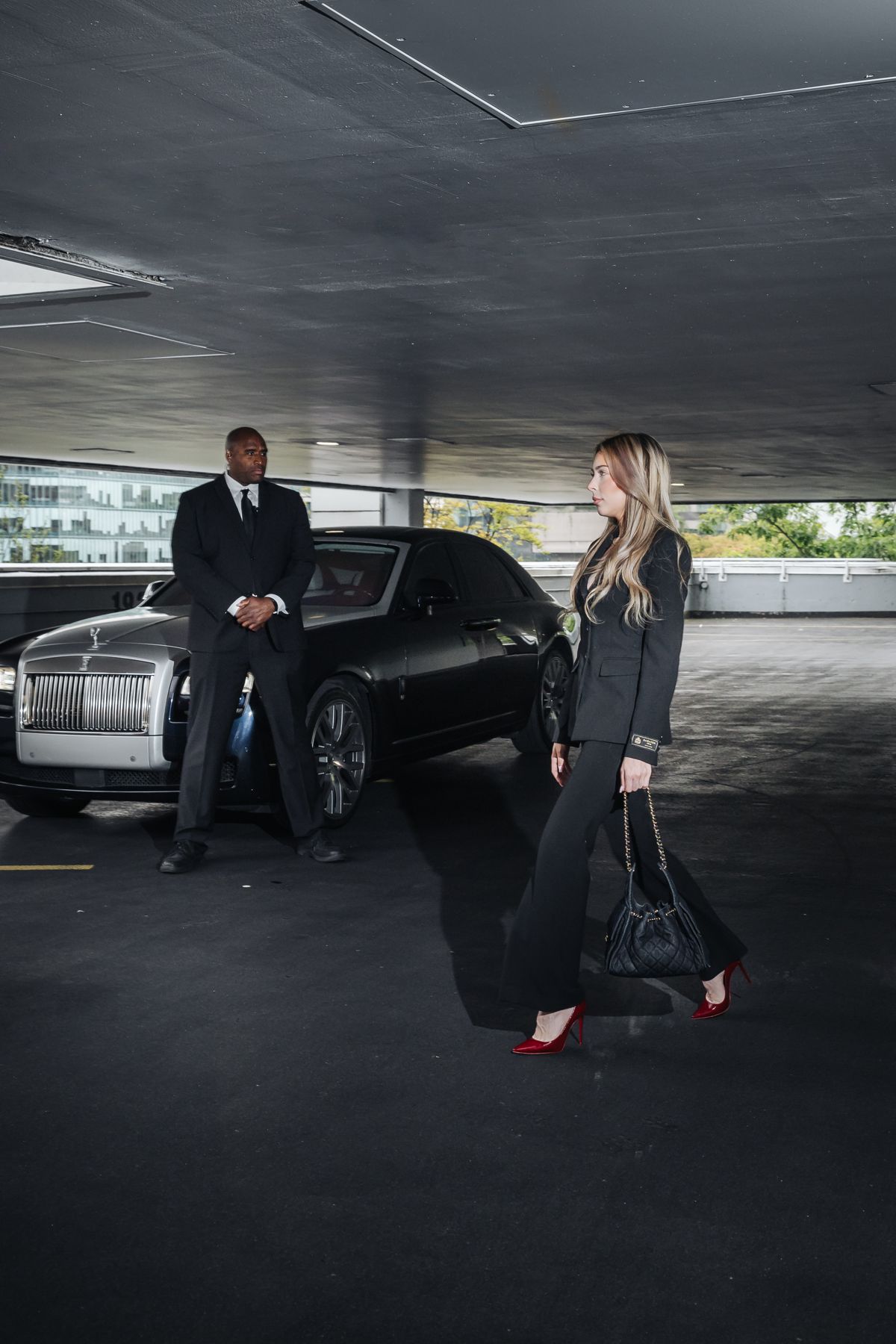 Officer escorting a client in a parking structure