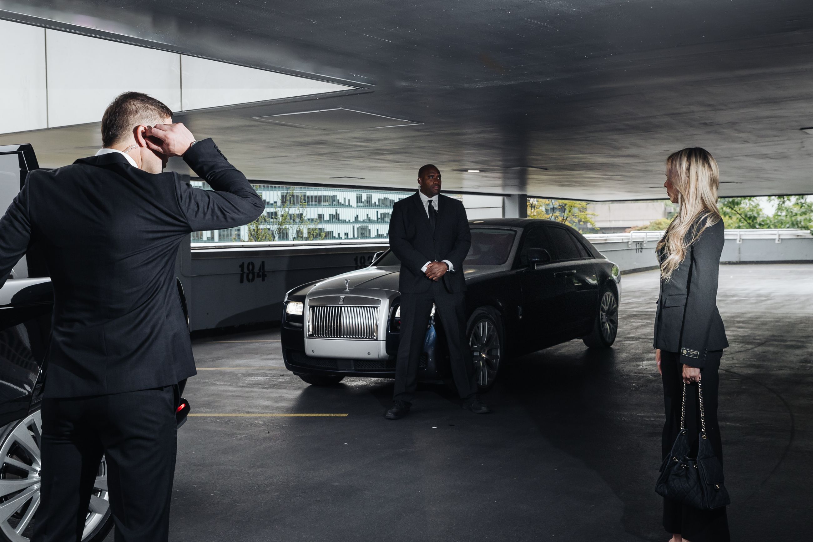 MI8 officers escorting a client to a Rolls-Royce